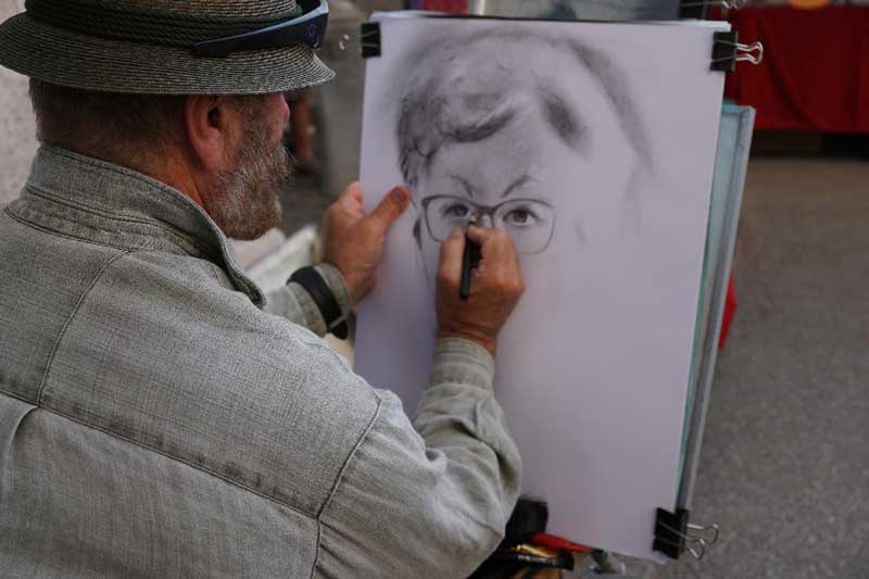 Man drawing a portrait of a boy