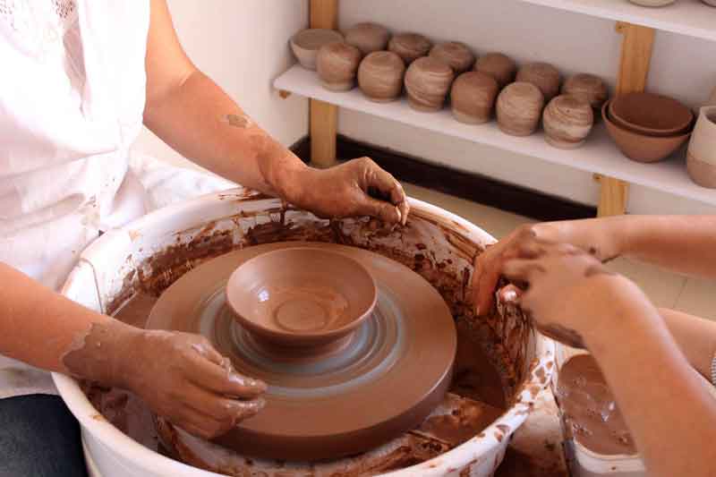 Professional pottery maker at her wheel