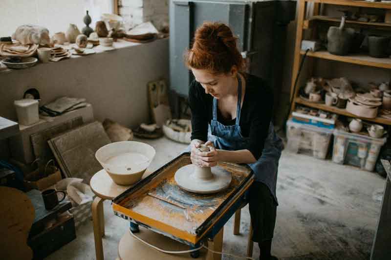Woman forming clay