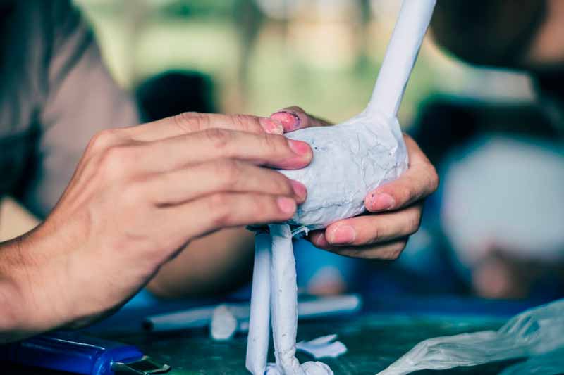 Hands making paper mache